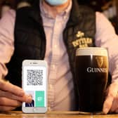 A barman in a Belfast pub ahead of a change to the rules around Covid certification