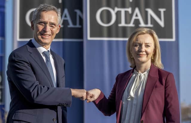 British Foreign Secretary Liz Truss, right, is greeted by NATO Secretary General Jens Stoltenberg prior to a meeting at NATO headquarters in Brussels, Monday, Jan. 24, 2022. (AP Photo/Olivier Matthys, Pool)