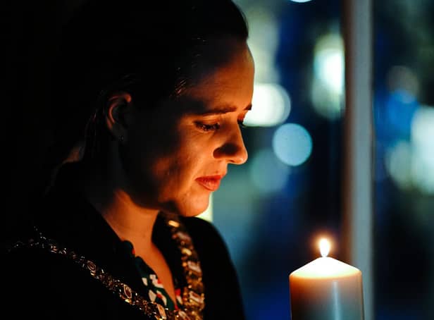 Belfast Lord Mayor Kate Nicholl lights a candle for HMD