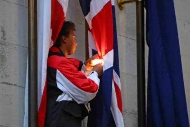 A unknown man trying to burn a Union flag at London's cenotaph in 2020