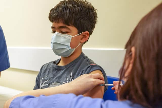Embargoed to 0001 Sunday January 30 Xavier Aquilina, aged 11, has a Covid-19 vaccination at the Emberbrook Community Centre for Health, in Thames Ditton, Surrey. Picture date: Saturday January 29, 2022.