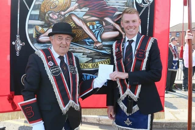 Russell White receives a presentation from his Worshipful Master Sir Knight Wesley Nelson (RBP 131) Pic courtesy of Banbridge Chronicle