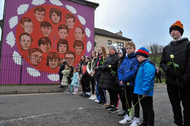 Bloody Sunday 50th anniversary event: relatives pass the mural on Westland Street depicting those killed in January 1972. Photo: George Sweeney.