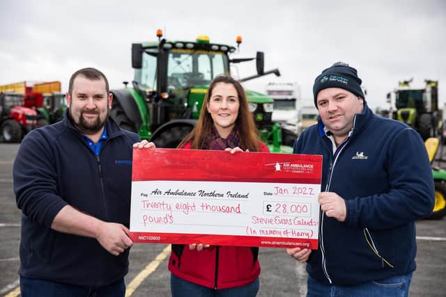 Stevie Evans from Kirkistown raised £28,000 from the sales of an agricultural calendar he dedicated to the memory of Master Harry Steele in aid of the Air Ambulance Northern Ireland charity. Pictured at the cheque handover which was held at Kirkistown Circuit are L-R; Stevie Evans, amateur photographer; Grace Williams, Air Ambulance NI; Samuel Steele, Harry's father. (Photo by Graham Baalham-Curry)