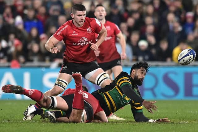 Ulster player Marcus Rea tackles Saints full back Ahsee Tuala who offloads during the Heineken Champions Cup match between Ulster Rugby and Northampton Saints at Kingspan Stadium on December 17, 2021 in Belfast, Northern Ireland. (Photo by Charles McQuillan/Getty Images).