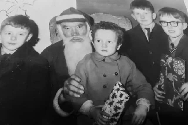 Jake is cute as a button visiting Santa aged approx three alongside his three younger brothers Connor, Barry and Damien. Today he might be 'pushing 60 but feels about 27' at heart. Perhaps a life in comedy prevents one's soul from growing old?