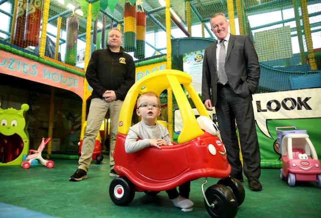 Pictured visiting Funky Monkeys in Kennedy Centre Belfast are Funky Monkeys business owner Bernard Mulholland with Cian Smith and Finance Minister Conor Murphy