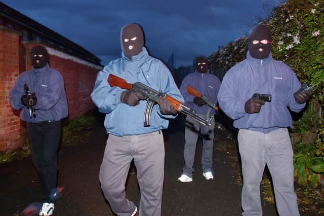Members of the South Belfast Brigade of the UDA pictured in the Taughmonagh estate - one of the group's principal strongholds