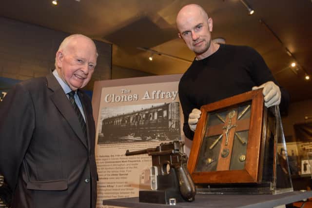 Undated handout photo issued by Monaghan County Museum of Gerard Fitzpatrick (left) with curator Liam Bradley and the display of artefacts, including Matt Fitzpatrick’s Mauser pistol and his crucifix, which were loaned to the museum by Gerard, who is a nephew of Matt Fitzpatrick, who was killed in a 1922 gun battle took place at a railway station in the border town of Clones that claimed the lives of several people. Issue date: Thursday February 10, 2022.