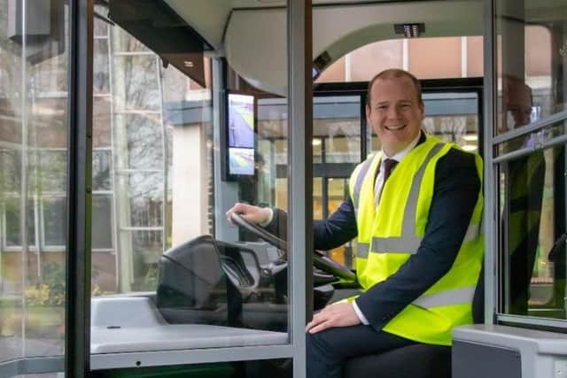Minister Lyons at the wheel of one of the buses