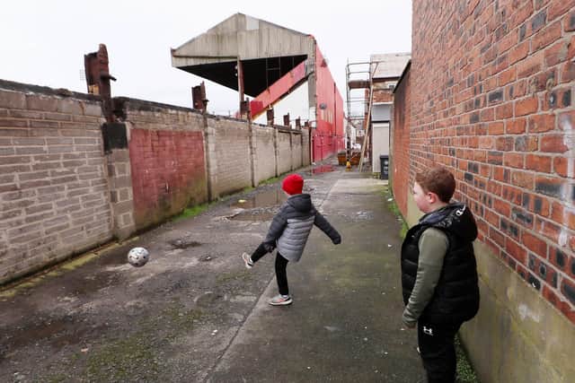 Mason McGrandles and Caoimhin McBride play football beside Solitude which is home to Cliftonville FC in north Belfast. 

Picture by Jonathan Porter/PressEye