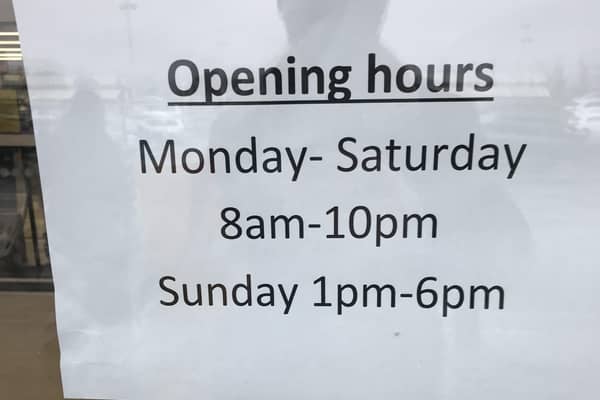 The shop opening hours, in black and white