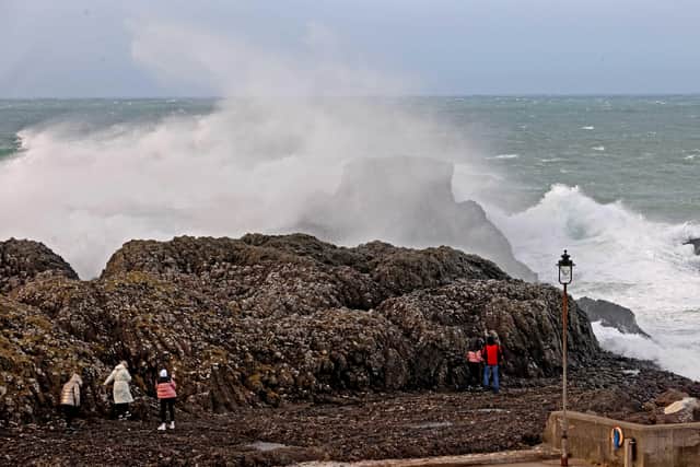 Members of the public gather at Ballintoy Harbour Co Antrim  as Storm Dudley arrived in  Northern Ireland.  Pic Steven McAuley/McAuley Multimedia
