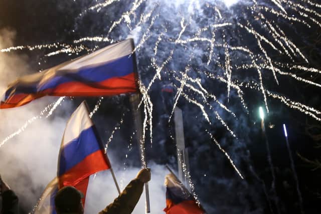 People wave Russian national flags to celebrate the recognising its independence, in Donetsk, the territory controlled by pro-Russian militants, eastern Ukraine, late Monday (AP Photo/Alexei Alexandrov)