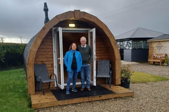 Isabel Gartlan-Ferguson and husband David Ferguson outside one of their luxory glamping pods in Ness Woods