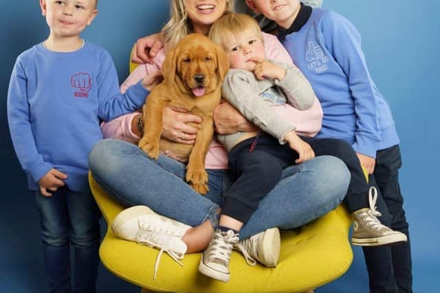 Sarah and Paul with Nate (left), Alfie (right) and Arthur on Sarah's knee with their dog Vinny