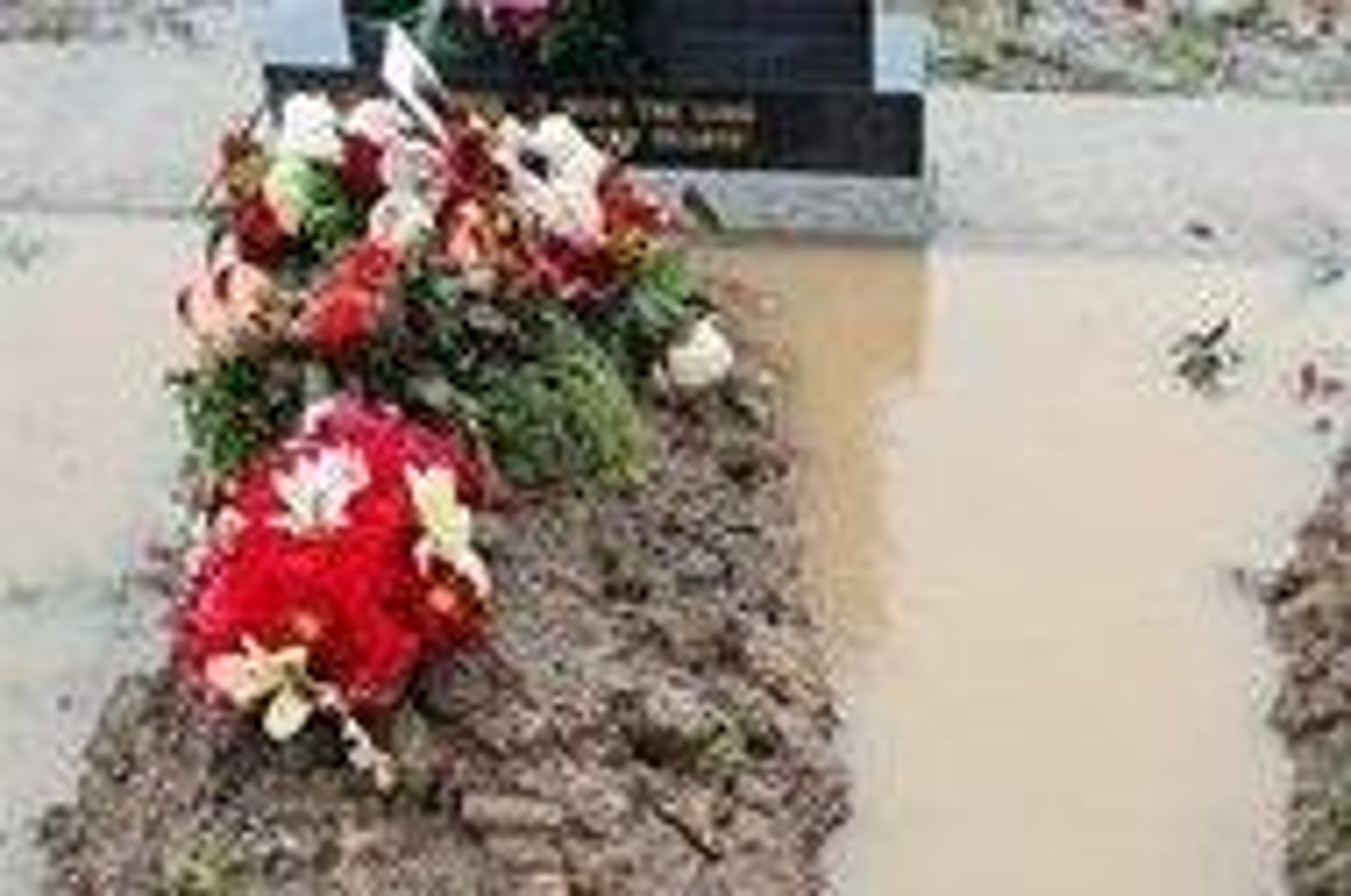 Widower's anguish as wife's grave is flooded
