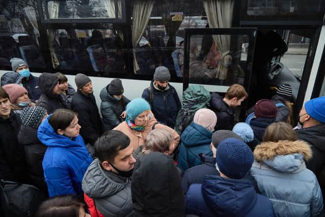 Kyiv residents queue for buses out of the city as news breaks that Russia has invaded Ukraine.