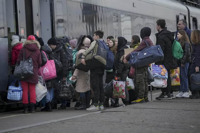 People board a Kyiv bound train on a platform in Kramatorsk, the Donetsk region, eastern Ukraine, on Thursday. Our first thoughts lie with the people of Ukraine, writes Stephen Farry (AP Photo/Vadim Ghirda)
