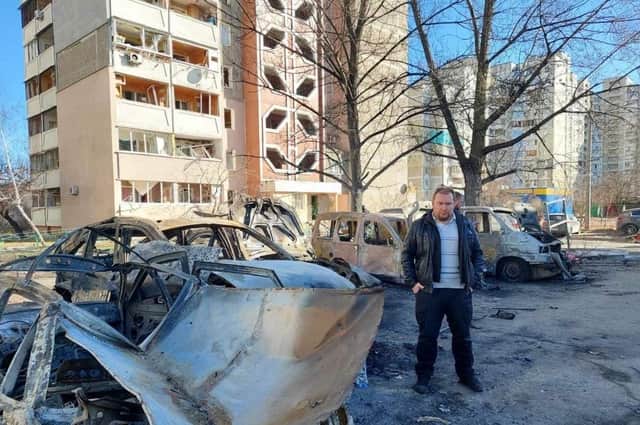 Undated handout photo of Vitaliy Rulyov next to burnt out cars in Kyiv, Ukraine, following shelling by Russian forces. Issue date: Monday February 28, 2022. PA Photo. See PA story POLITICS UkraineKyiv. Photo credit should read: Vitaliy Rulyov/PA Wire 

NOTE TO EDITORS: This handout photo may only be used in for editorial reporting purposes for the contemporaneous illustration of events, things or the people in the image or facts mentioned in the caption. Reuse of the picture may require further permission from the copyright holder.