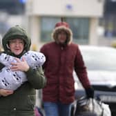 A family arrive at the border crossing in Medyka, Poland after fleeing from the Ukraine.  (AP Photo/Markus Schreiber)
