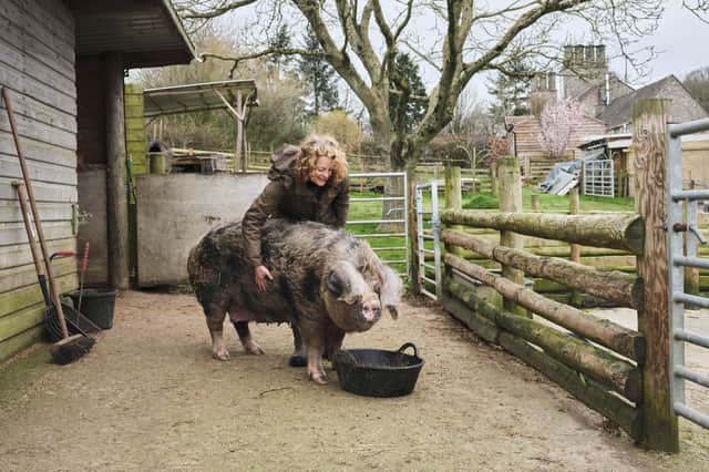 Kate Humble with a pig on her farm in Wales
