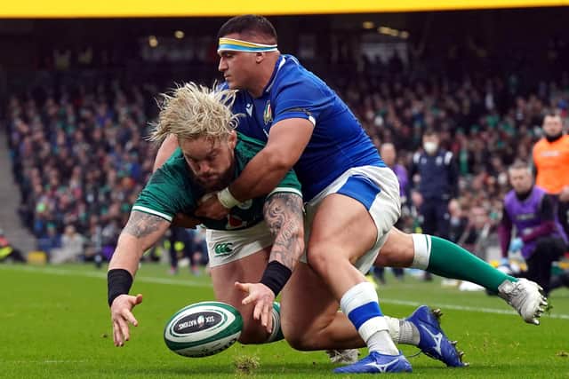 Ireland's Andrew Porter is tackled by Italy's Danilo Fischetti.
