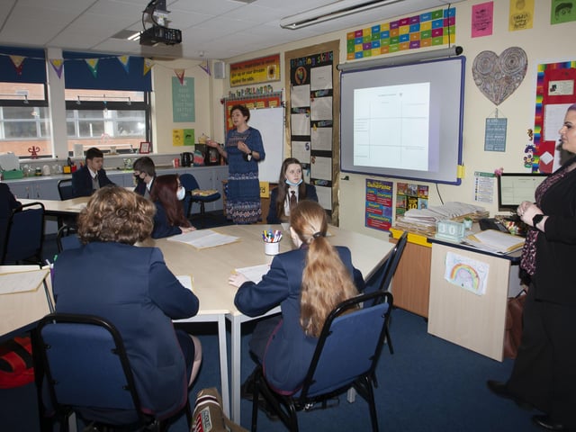 Mrs Colvin and Ms Breslin, MEE teachers, pictured with a class of Year 9 students who took part in a lesson attended by the Mayor, Alderman Graham Warke and Professor O'Neill.