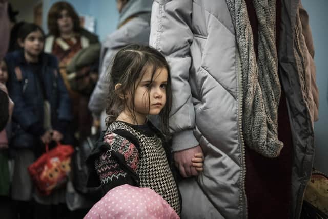 Children and their companions from an orphanage in Odesa, Ukraine, wait for room allocation after their arrival at a hotel in Berlin, Friday, March 4, 2022 s)