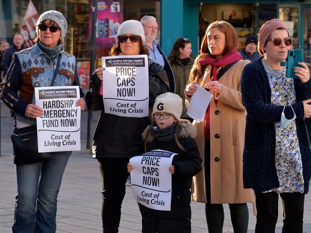 People carry placards at the Derry Against Fuel Poverty protest in Waterloo Square on Saturday afternoon last. Photo: George Sweeney.  DER2209GS – 057