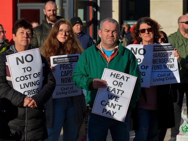 People carry placards at the Derry Against Fuel Poverty protest in Waterloo Square on Saturday afternoon last. Photo: George Sweeney.  DER2209GS – 061