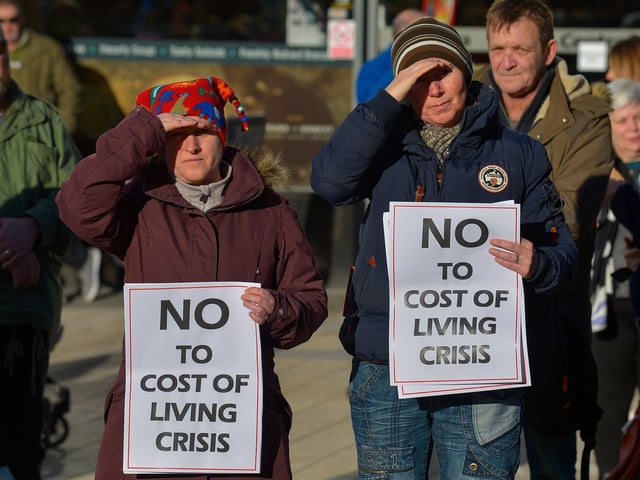 People carry placards at the Derry Against Fuel Poverty rally in Waterloo Square on Saturday afternoon last. Photo: George Sweeney.  DER2209GS – 062