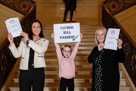 (L-R) Autism NI CEO Kerry Boyd, Hannah Armstrong (8) and Pam Cameron MLA at Stormont celebrating the passing of the Autism Amendment Bill on Monday 7th March 2022.