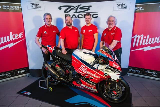 Ian Hutchinson with TAS Racing's Philip and Hector Neill, and Milwaukee's Dale McElveen.