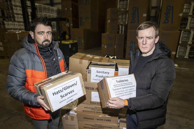 Paul Doherty (left), founder of Woodstock in west Belfast and SDLP MLA Justin McNully offloading donations given by people from Co. Armagh, at global transport and logistics company, DSV, in Belfast that will  be packaged and shipped to go to the people of Ukraine. Picture date: Tuesday March 8, 2022. PA Photo. See PA story POLITICS UkraineUlster. Photo credit should read: Liam McBurney/PA Wire