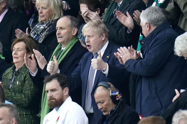 Taoiseach Michael Martin and Prime Minister Boris Johnson (right) in the stands during the Guinness Six Nations match at Twickenham Stadium, London.  Photo: Andrew Matthews/PA