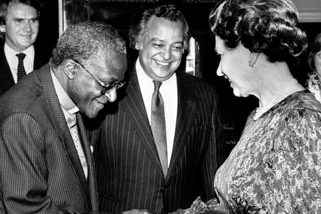 Queen Elizabeth II meeting the Anglican Archbishop of Cape Town, Desmond Tutu at a Commonwealth Day Reception at Marlborough House, London, with Sir Shridath Ramphal, Secretary-General of the Commonwealth in 1987