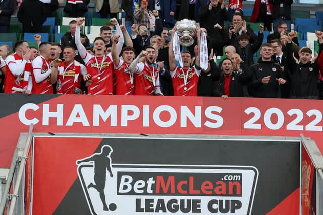 Cliftonville's Chris Curran lifts the BetMcLean League Cup trophy at the National Stadium following a thrilling final against Coleraine. Pic by Pacemaker.