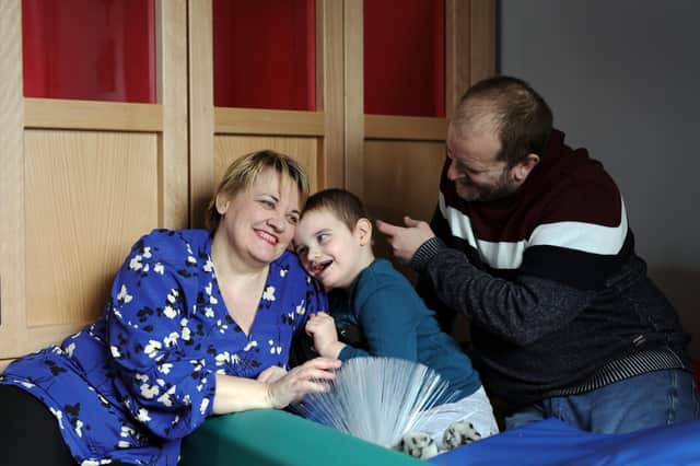 Lisa and John Faulkner with their son John Luke, who has the rare genetic condition, Angelman Syndrome