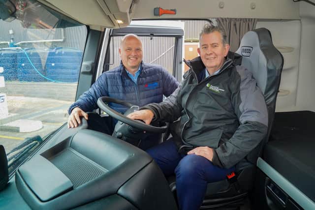 Environment Minister Edwin Poots pictured with Ashley McCulla chairman McCulla (Ireland) Limited at the wheel of the one of the new vehicles