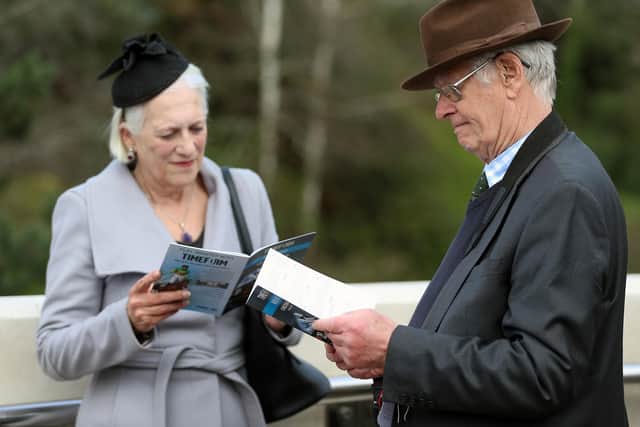 Racegoers study the form ahead of day one of the Cheltenham Festival.
