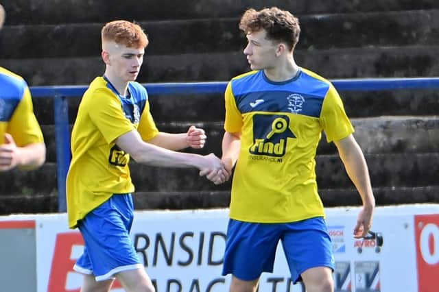 St Columb's College defender Rory O'Donnell is congratulated by Tiernan McKinney after firing home the opening goal against St Louis Grammar. Picture by Stephen Hamilton