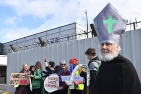 A protestor dressed as St Patrick at the Thales factory in Belfast