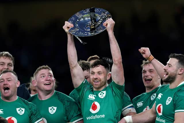 Ireland's Hugo Keenan celebrates with the triple crown trophy after the Guinness Six Nations match at the Aviva Stadium in Dublin, Ireland. Picture date: Saturday March 19, 2022.