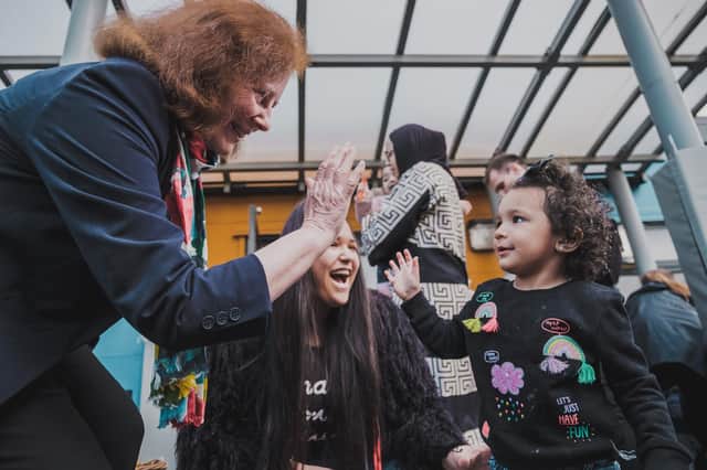Welsh deputy minister for social services Julie Morgan high-fives a child in celebration of the new law banning the physical punishment of children. The physical punishment of children is now outlawed in Wales.
