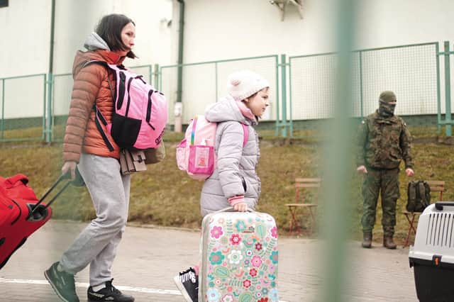 A family crossing the border point from Ukraine into Medyka, Poland.