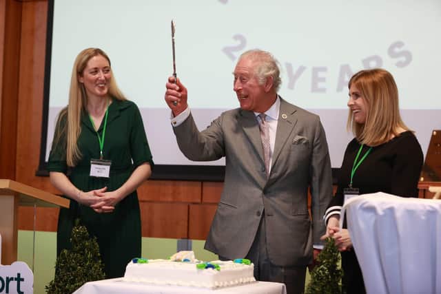 The Prince of Wales cuts a cake celebrating Rural Support Northern Ireland's 20th Anniversary during a visit to the College of Agriculture Food and Rural Enterprise in Cookstown.
