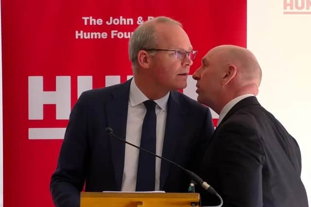 Screengrab taken from video issued by the Hume Foundation of Simon Coveney about to be ushered from the room due to a security alert.