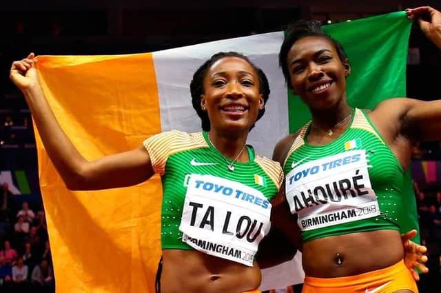 Marie-Josee Ta Lou and Murielle Ahoure - two Ivory Coast athletes who were unable to find their national flag at the 2018  World Indoor Athletics Championships... so they turned an Irish one upside down!