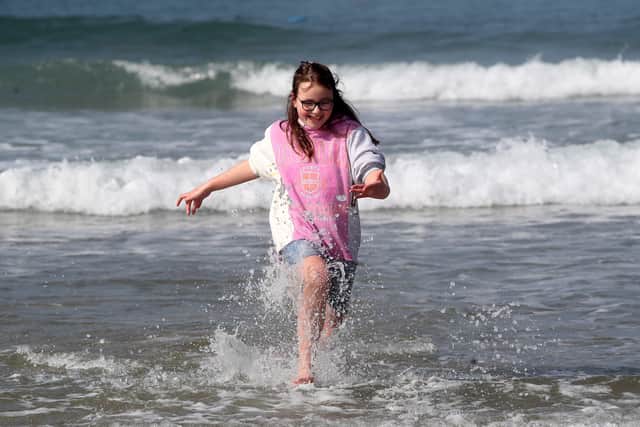 Olivia Irwin enjoying the waves and sunshine on Portrush West Strand.
